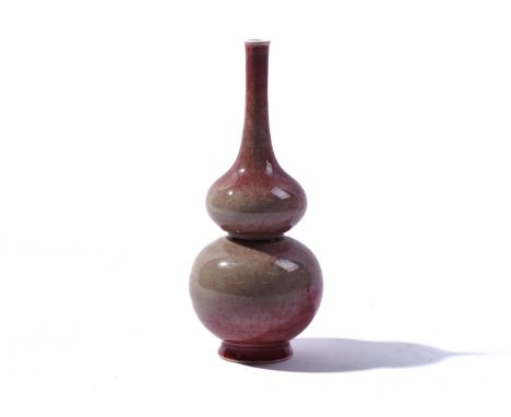 A CHINESE `PEACH BLOOM' GLAZED VASEBlue six character Kangxi mark but laterOf double gourd form covered in a mottled red glaz