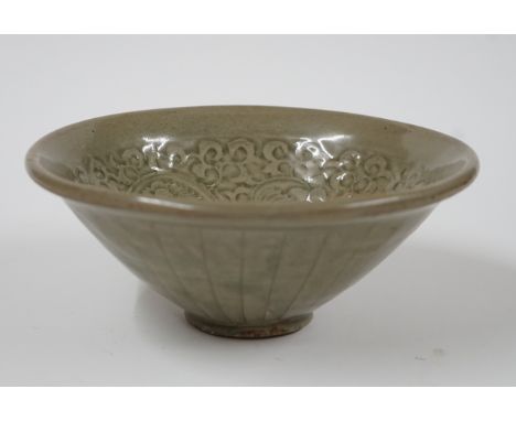 A CHINESE CELADON GLAZED BOWLSong style but possibly laterOf deep conical shape, the interior moulded with a flowerhead surro