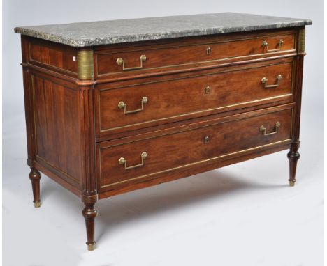 A FRENCH DIRECTOIRE 19TH CENTURY MAHOGANY AND BRASS MOUNTED COMMODEWith grey fossil marble top above three long drawers, 130c