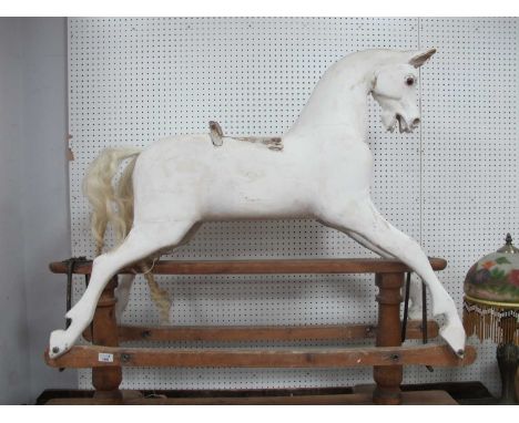 XIX Century White Painted Wooden Rocking Horse, with haired tail, on pine trestle base,122cm wide (restoration required).Appr