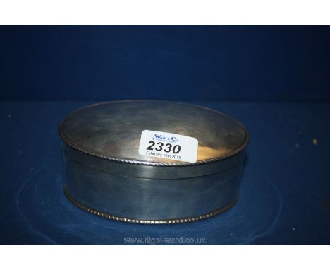 A white metal oval Tea Caddy