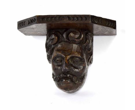 Antique carved oak head, detailing a gentleman with moustache, later bracket, probably 17th century, 5.5" high, 7.5" wide