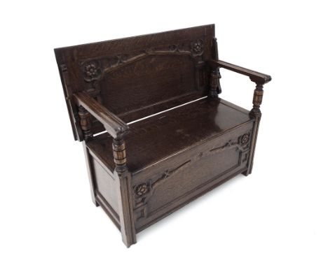 Arts & Crafts style oak monks bench with Gothic Revival mouldings, the folding top over a hinged box seat, 42" wide