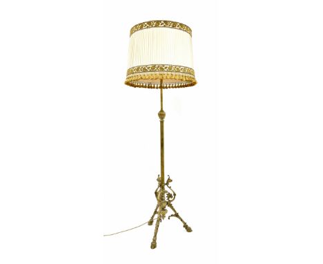 Telescopic brass standard lamp, the tripod base with sea horse and cast hoof feet, with shade