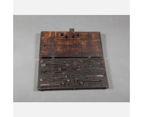 Tibet Operation Tool Set, iron forged instruments with decorations, in original wooden box, with metal mounts, 35 x 65 cm
