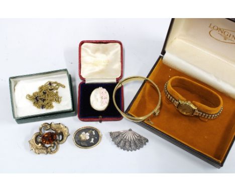 A collection of brooches to include a cameo brooch, mourning brooch with hair locket verso, and two others, gold plated stiff