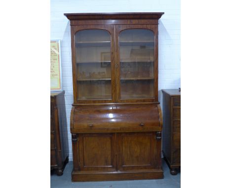 19th century mahogany secretaire bookcase cabinet, the cornice top over two glazed doors with a shelved interior, above a rol