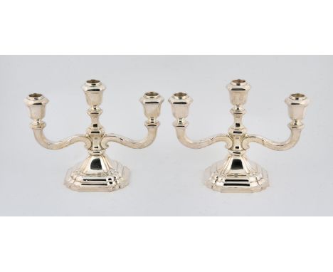 A pair of silver three light  candelabra with loose glass drip pans, marked sterling, H20cm gross weight 34.4oz 1071gm