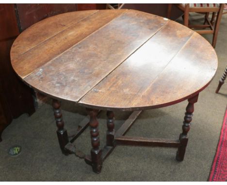 An 18th century oak gate leg table, 107cm by 120cm (open) by 68cm 