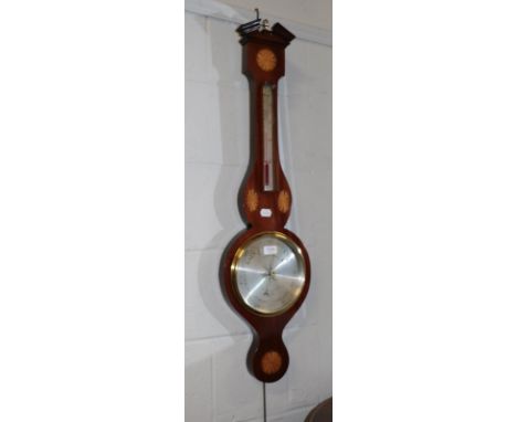 A mahogany inlaid aneroid wheel barometer, silvered dial signed Negretti &amp; Zambra, Instrument Makers To Her Majesty, Lond