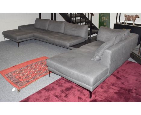 A contemporary Roche Bobois grey corner sofa with chrome feet and integral table top, 420cm by 220cm by 65cm 