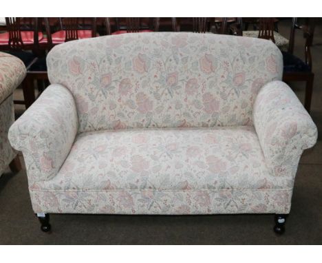 A mahogany framed two seater drop arm sofa, 138cm by 77cm by 84cm
