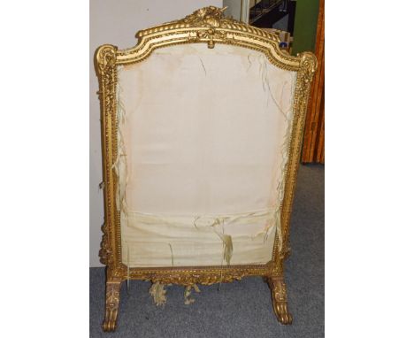 A 19th century French giltwood and gesso firescreen of country house proportions, ornately carved with musical trophies, scro