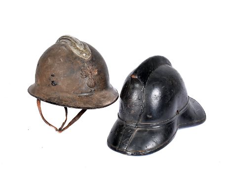 A WWI period French Adrian steel helmet, having applied RF badge to the front and possibly later comb, complete with chin str