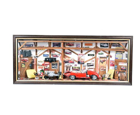 A Jaguar Garage Diorama, the workshop featuring a red Jaguar E-Type being worked on, with the engine and seats removed, with 