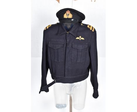 A Fleet Arm Arms uniform, comprising Battle Blouse, post war, two pairs of trousers, a peak cap, an Air Ministry  marked Life