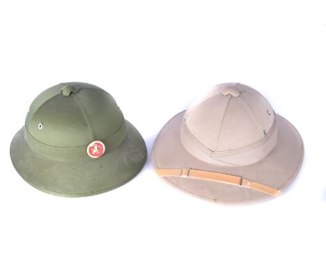 A Khaki Pith helmet, possibly Indian, together with a green Pith helmet, with Chinese Star badge to the front (2) 