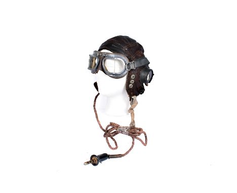 A Type C flying helmet, the brown leather helmet stamped with a serial number, completely wired with speaker ear phones, and 