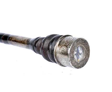 A white metal topped walking cane with built in compass, the white metal top with built in compass, decorated with interlocki