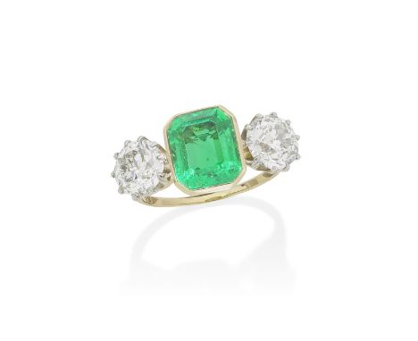 EMERALD AND DIAMOND THREE-STONE RINGThe step-cut emerald between two old brilliant-cut diamonds, weighing 1.67 carats and 1.7