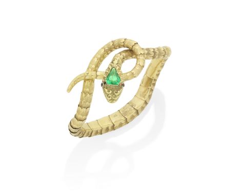 GOLD AND EMERALD SNAKE BRACELET, CIRCA 1830-5Of sinuous coiling form, the body composed of overlapped scales of polished and 