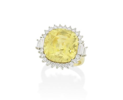 YELLOW SAPPHIRE AND DIAMOND RINGThe cushion-shaped yellow sapphire, weighing 24.06 carats,  in a brilliant-cut diamond surrou