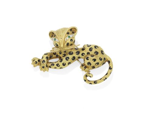 FRED: ENAMEL AND GEM-SET LEOPARD BROOCH, CIRCA 1960The textured body with black enamel spots, circular-cut emerald and brilli