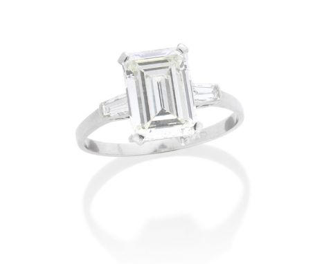 DIAMOND SINGLE-STONE RINGThe step-cut diamond, weighing 3.77 carats, to tapering baguette-cut diamond shoulders, ring size R½
