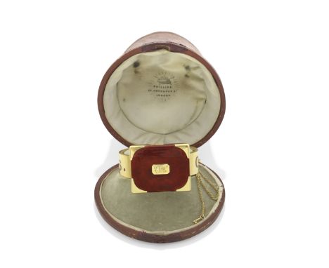 GOLD AND ENAMEL HINGED NOVELTY BANGLE, CIRCA 1860Designed as a locked gun case, with burnt orange guilloché enamel lid in a s