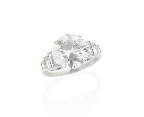 DIAMOND SINGLE-STONE RINGThe old brilliant-cut diamond, weighing 5.44 carats, between stepped baguette-cut diamonds,  ring si