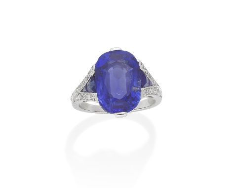 SAPPHIRE AND DIAMOND RING, CIRCA 1930The oval-cut sapphire, weighing 10.83 carats, between bifurcated shoulders set with old 