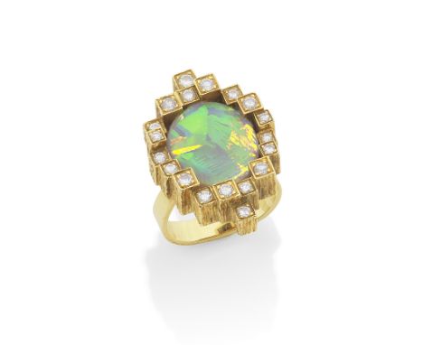 GRIMA: OPAL AND DIAMOND DRESS RING, 1984The oval opal cabochon within a heavily engraved castellated border set with brillian