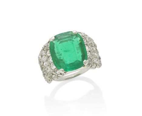 EMERALD AND DIAMOND RING, CIRCA 1935The cushion-shaped emerald, weighing 5.93 carats, shoulders set with triple rows of old b