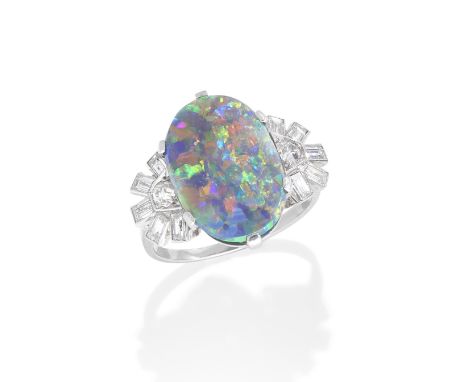 BLACK OPAL AND DIAMOND RING, CIRCA 1950The oval opal between fan-shaped shoulders of old brilliant and baguette-cut diamonds,