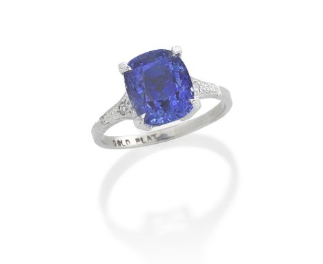 SAPPHIRE AND DIAMOND RINGThe cushion-shaped sapphire, weighing 6.31 carats, between two single-cut diamonds, ring size M½, ca