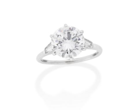 RETAILED BY CARTIER: DIAMOND SINGLE-STONE RINGThe brilliant-cut diamond, weighing 4.19 carats, between two tapered baguette-c