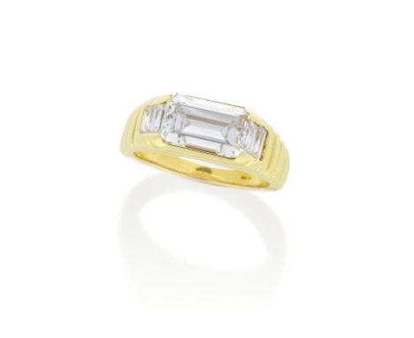 DIAMOND RINGThe step-cut diamond horizontally set, weighing 3.12 carats, in a reeded mount with baguette-cut diamond shoulder