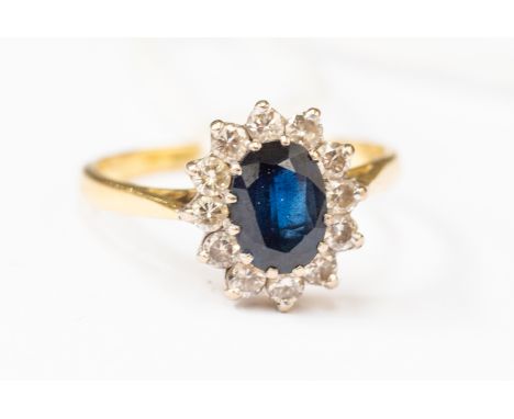 A Sapphire and diamond cluster ring set in 18 ct gold, set with an oval sapphire approx 1.0 carat, size P1/2, total gross wei