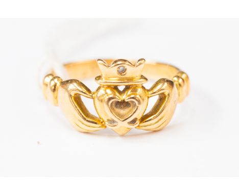 An 18ct gold Claddagh ring, set with a small diamond, 18ct Irish gold, size M, total gross weight approx 4.5 gms