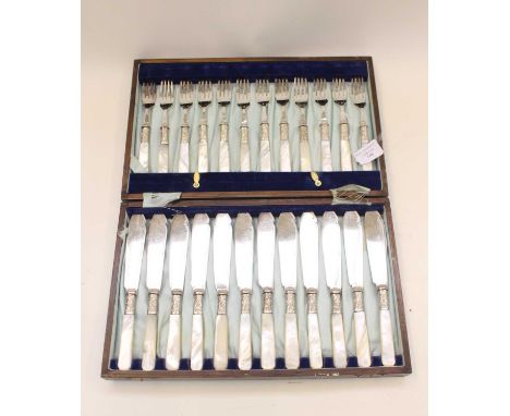 An early 20th Century oak cased fish knife and fork set, silver plated with mother of pearl handles
