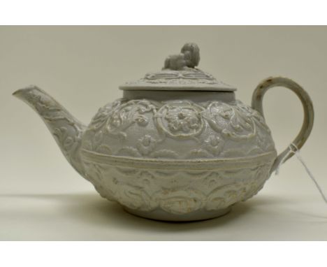 A salt glaze teapot with lion finial, white glaze with moulded detail