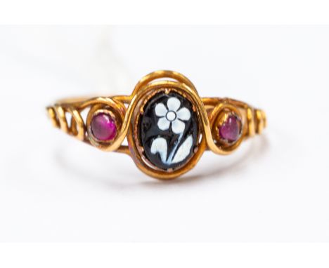 A Victorian yellow metal ladies dress ring, enamelled flower to centre, rose coloured stone to each side, ring size 'M'