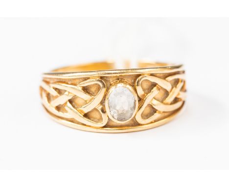 A blue topaz and 9 ct gold ring, comprising interlocking Celtic decoration set to the centre with an oval blue topaz, size Q1