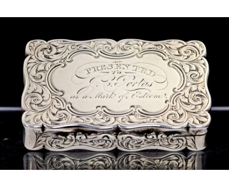 A Victorian silver snuff box, shaped rectangular the hinged cover and base profusely engraved with foliage, the cover with ce