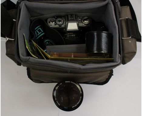 A Minolta SLR XG-M 49mm, together with an automatic zoom lens (in case) filters, light meters etc all in camera shoulder bag