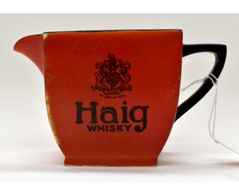 A Carlton Ware Haig whisky jug, early 20th Century, black decoration on a red ground, stamped to base