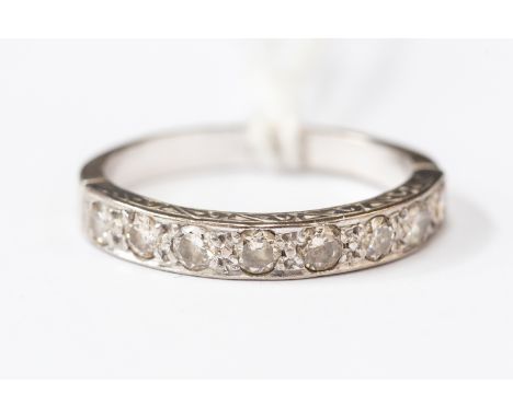 A diamond half hoop ring set with seven diamonds each approx 0.05 ct, stamped 18ct, size L1/2, approx 2.5gms