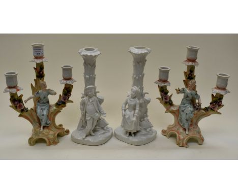 Two pairs of ceramic candlesticks, one pair with blue crossed sword marks (4)