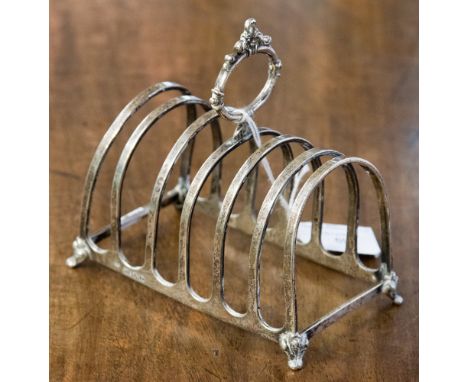 A George VI silver six tier toast rack, arched form with foliate moulded oval handle, on bracket feet, maker Robert Pringle &