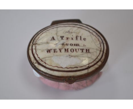 An 18th Century Bilston enamel oval patch box, circa 1780, the cover with motto 'A Trifle from Weymouth', mirrored inner cove